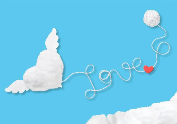 text love with red heart from rope on blue background