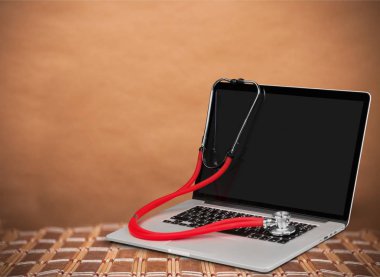 Modern dizüstü ve arka plan üzerinde stetoskop