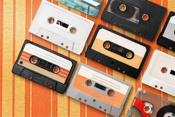 Collection of retro audio tapes on background