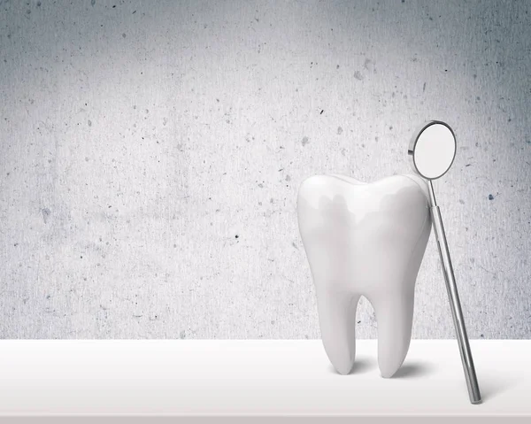 Big tooth and dentist mirror — Stock Photo, Image