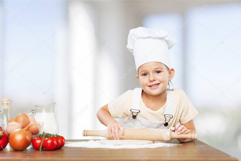 Little girl Cooking with dough isolated on  background