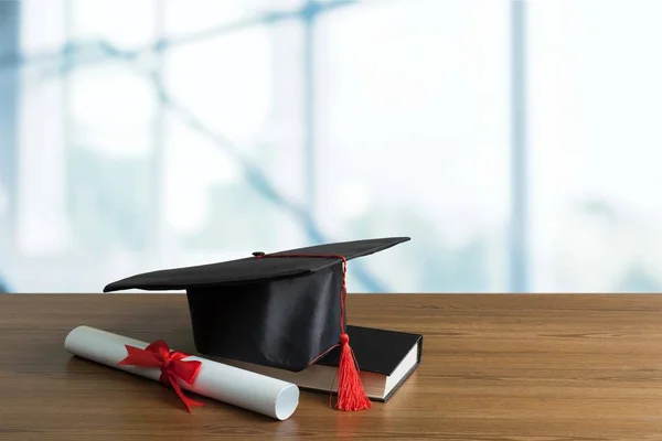 卒業の帽子 テーブルに卒業証書 — ストック写真
