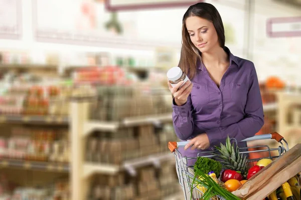 Happy woman with shopping cart — Stock Photo, Image