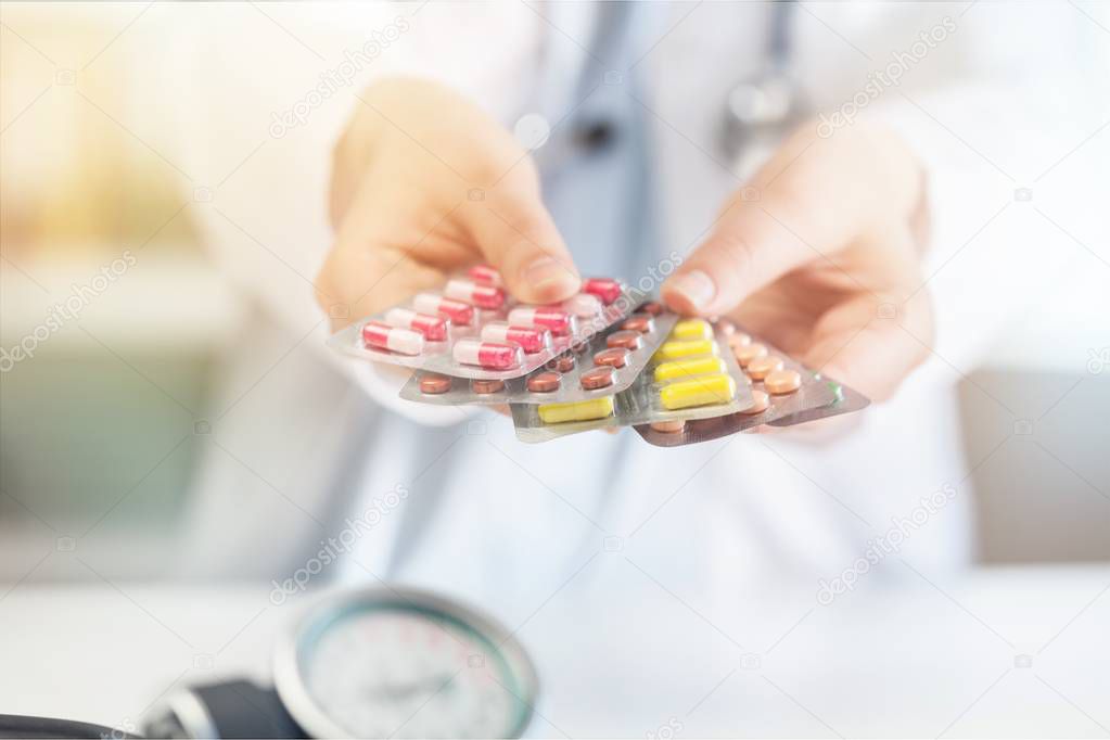 Close-up view of young female doctor holds the pills