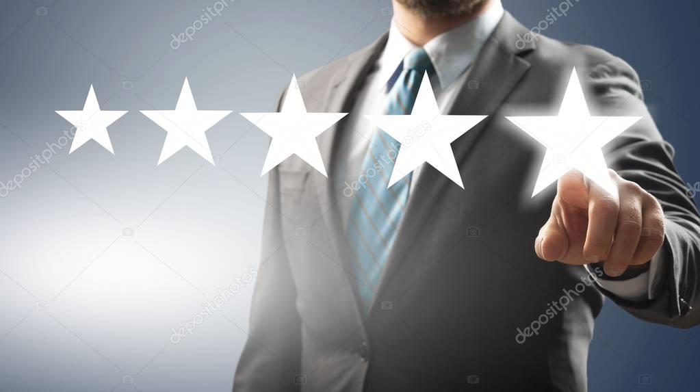 Young businessman ranking with his hand using digital stars rendering
