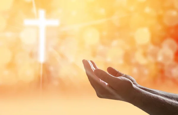 Hands of human praying on light background