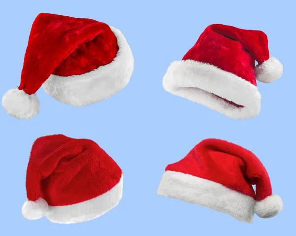 红色圣诞老人帽子收集在光背景下 — 图库照片