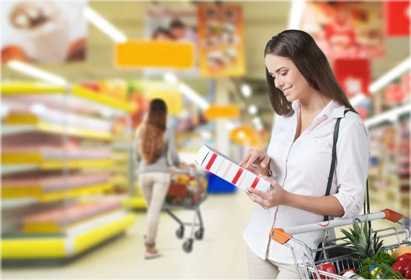 Happy woman with shopping cart — Stock Photo, Image