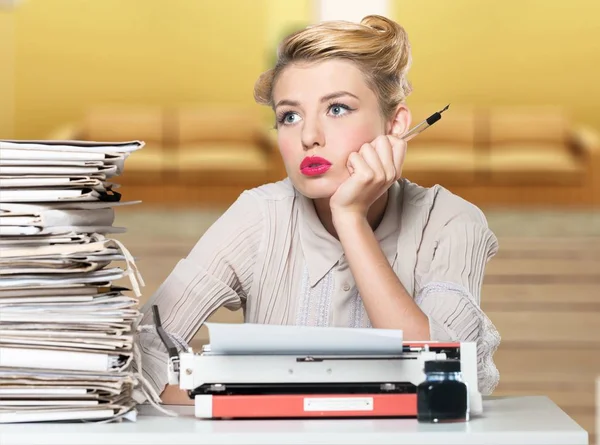 Woman working on vintage typewriter