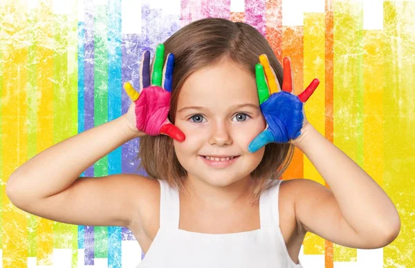 Little girl showing painted hands — Stock Photo, Image