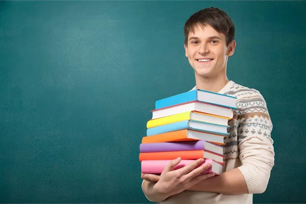 Selbstbewusster Gutaussehender Mann Mit Büchern Auf Grünem Hintergrund — Stockfoto