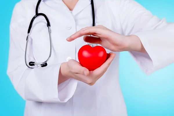 Red Heart in hands of female doctor