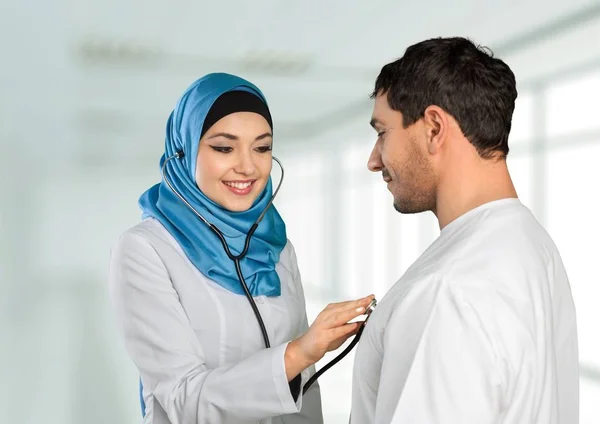 Arabic female doctor  talking with a patient