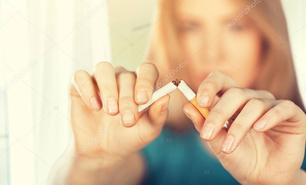portrait of young woman crushed cigarette