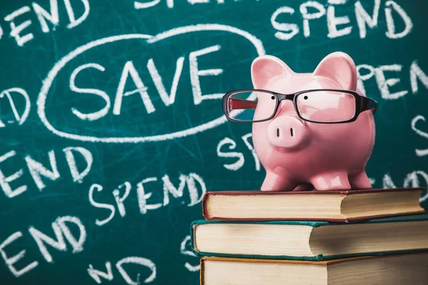 Piggy Bank Glasses Books Green Background — Stock Photo, Image