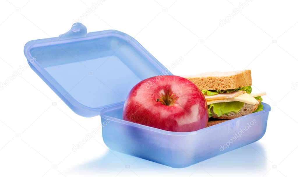Lunchbox with red apple and sandwich on white background