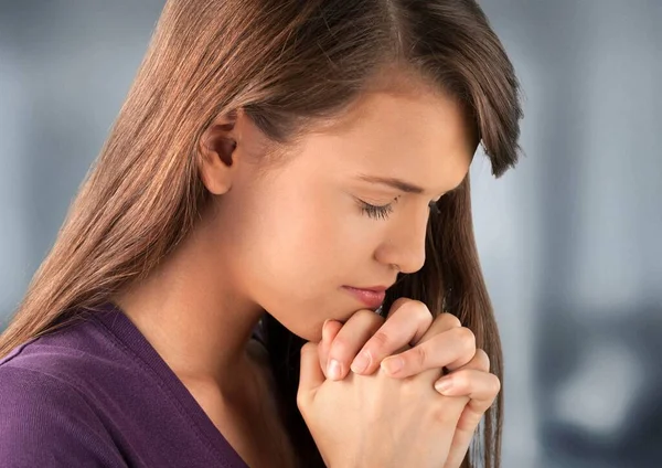 Young Woman Praying Light Background — Stock Photo, Image