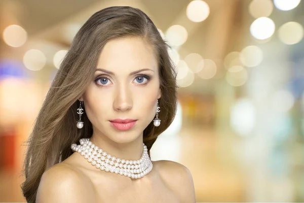 portrait of young beautiful woman in necklace