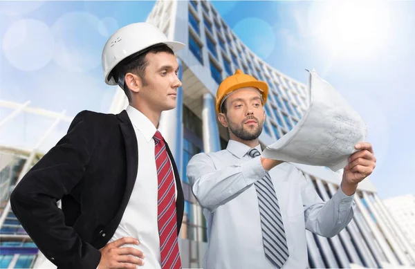Two Male Architects Holding Blueprint Discussing — Stock Photo, Image