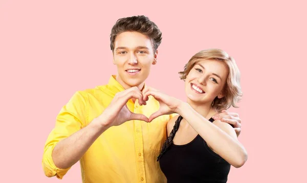 happy couple in love making heart shape on  background
