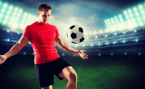young man with soccer ball on stadium