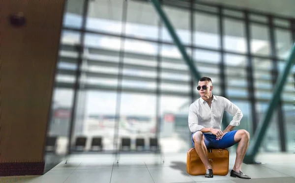 young handsome man in airport waiting for boarding