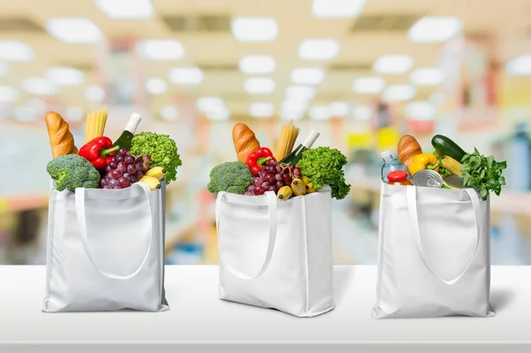 food in the supermarket in reusable bags