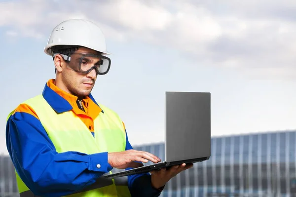 engineer builder using laptop at construction site