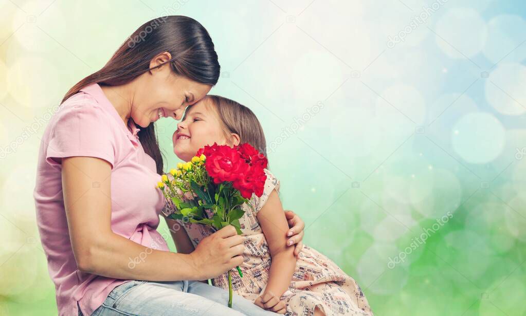 mother and daughter holding bouquet of flowers