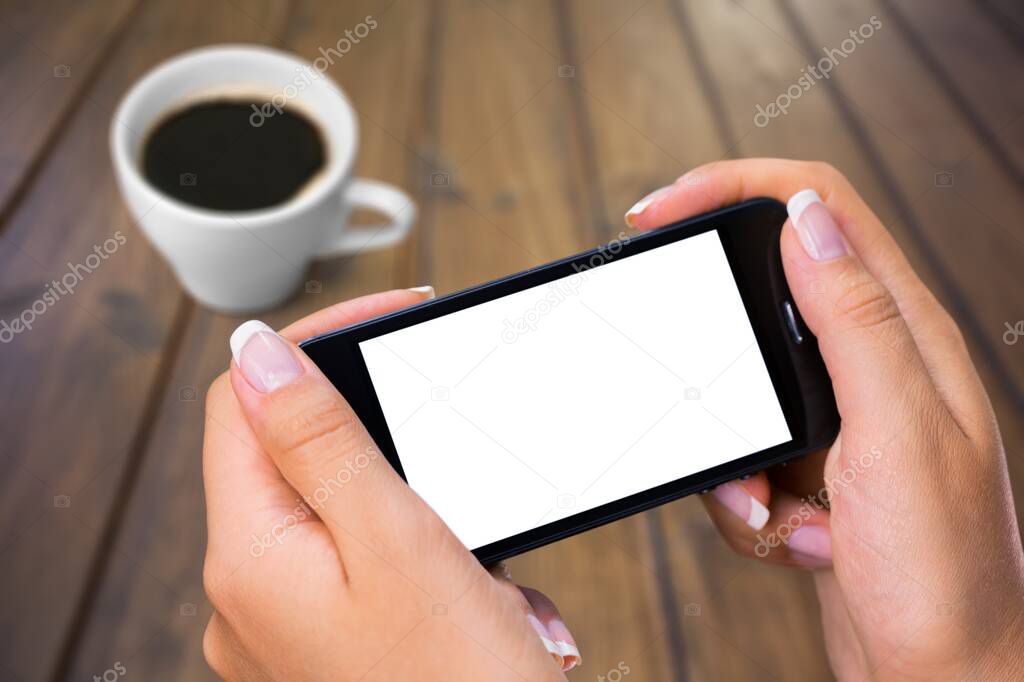 female hands  with coffee and  mobile phone 