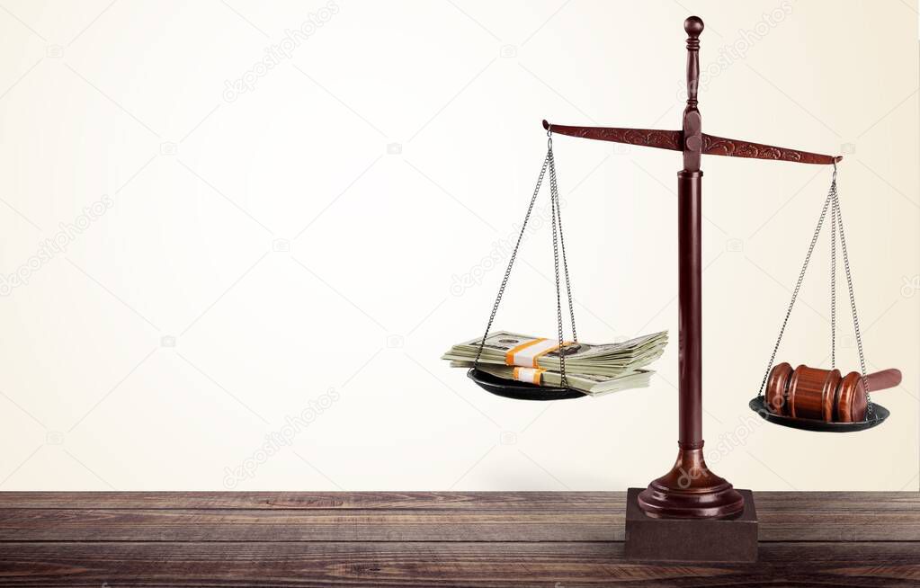 Law scales and money on table background. Symbol of justice