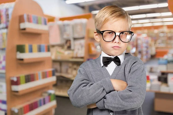 图书馆里一个戴眼镜的小男孩的肖像 — 图库照片