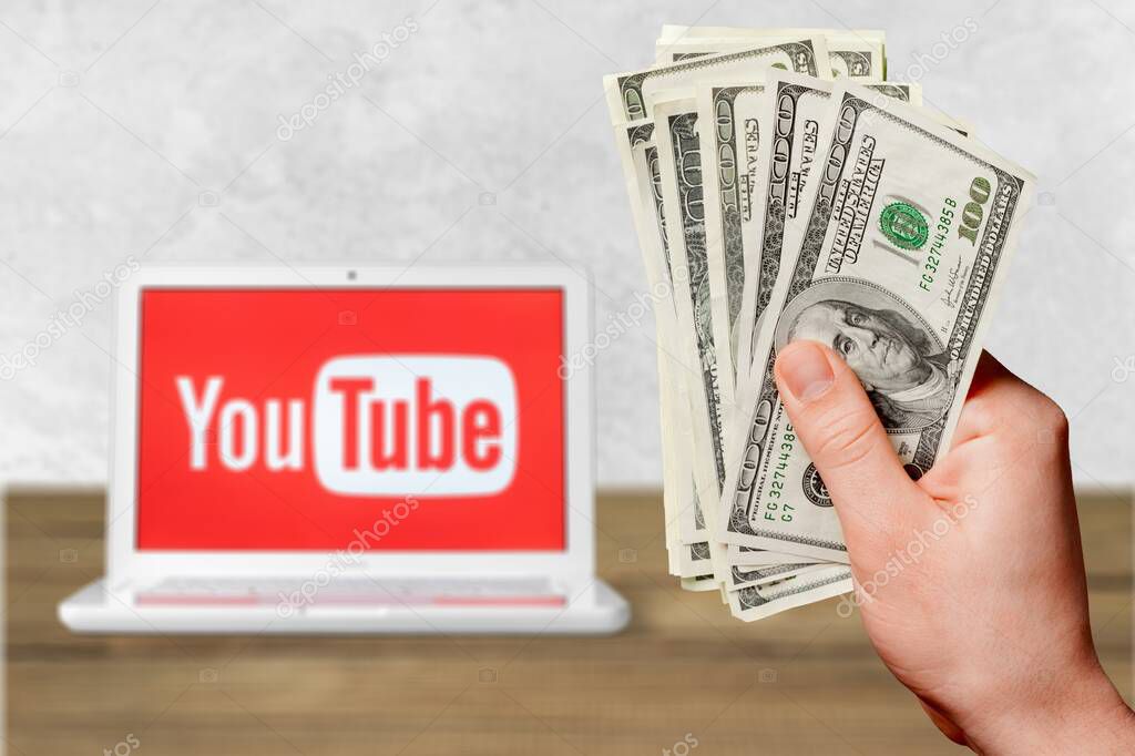 Hand with   money and YouTube logo
