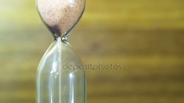 Hourglass on a Wooden Background, the Sand Falls Inside — Stock Video
