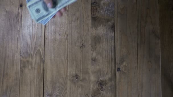 Man handen overwegen Dollar biljetten op een houten tafel. Slow Motion — Stockvideo