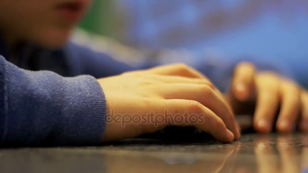 Child Playing with Mobile Phone on the Table — Stock Video