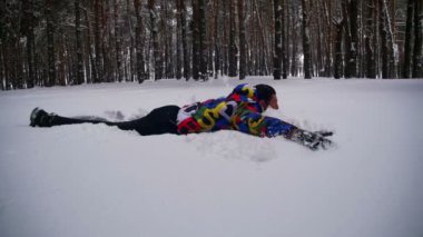 Mutlu bir adam dalış derin kar ve kış çam ormanı içinde eğleniyor. Ağır çekim