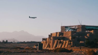 Yolcu uçağı gökyüzünde dağlar ve palmiye ağaçları Mısır arka plan üzerinde açılış.