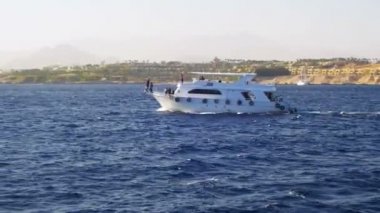 Zevk tekne yüzen Kızıldeniz sahilleri ve plajları Mısır arka plan üzerinde dalgaların üzerinde