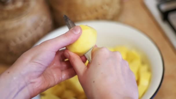 Peeling aardappelen in de keuken thuis. Slow Motion — Stockvideo