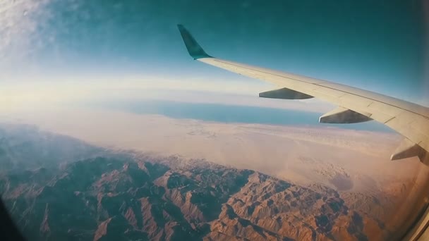 Vista desde una ventana de avión sobre las nubes — Vídeo de stock