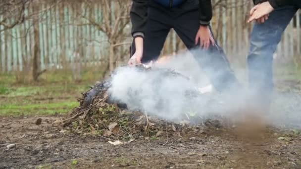 Unrat, Laub, kleine Bäume und Unkraut im Garten auf dem eigenen Grundstück verbrennen. Zeitlupe — Stockvideo