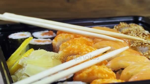 Rolos de sushi japonês com pauzinhos gira — Vídeo de Stock