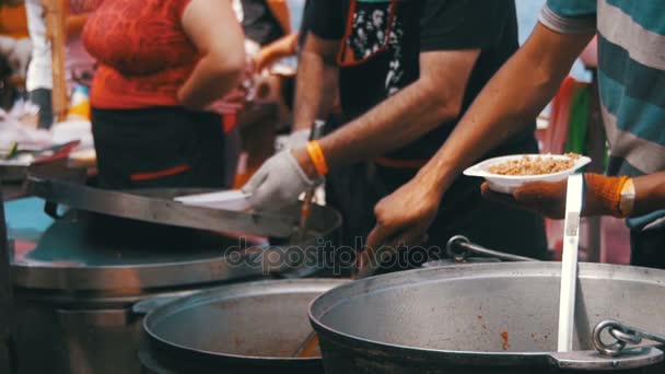 Chef vende comida preparada en el mercado callejero en la fiesta de barbacoa. Moción lenta — Vídeo de stock