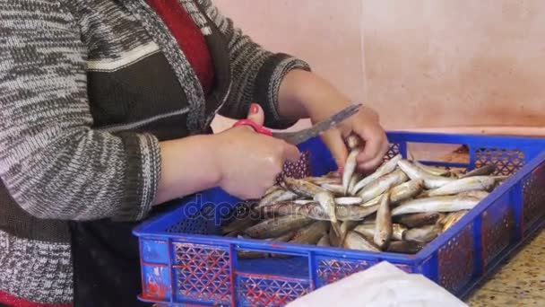 Fischverkäufer schuppt und schneidet Fisch im Marktstand — Stockvideo