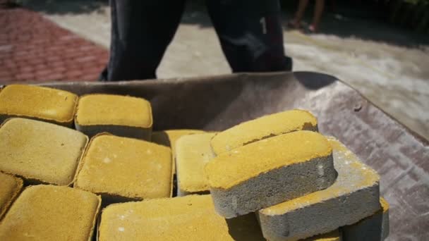 Construction Site, the Construction Worker Unloads the Stone Paving from the wheelbarrow. Slow Motion — Stock Footage Construction Site, the Construction Worker Unloads the Stone Paving from the wheelbarrow. Slow Motion Royalty Free Stock Footage