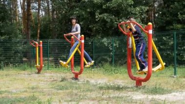 Anne ve oğlu spor eğitim simülatörleri üzerinde spor için içeri