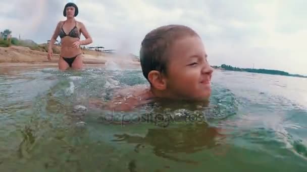 Mom Teaches the Child to Swim in the River — Stock Video