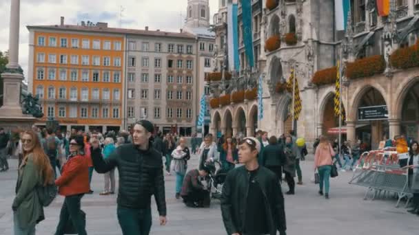 Multitud de personas caminando en la plaza Marienplatz en el famoso Ayuntamiento. Munich, Alemania — Vídeo de stock