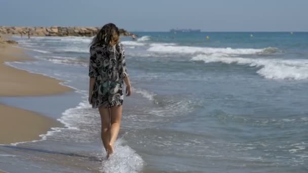 Young Girl Walks along the Beach of the Sea Coast in Slow Motion — Stock Video